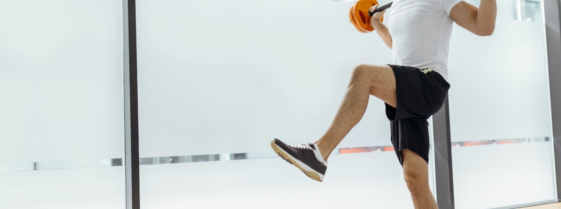 Handsome man exercising and lifting weights